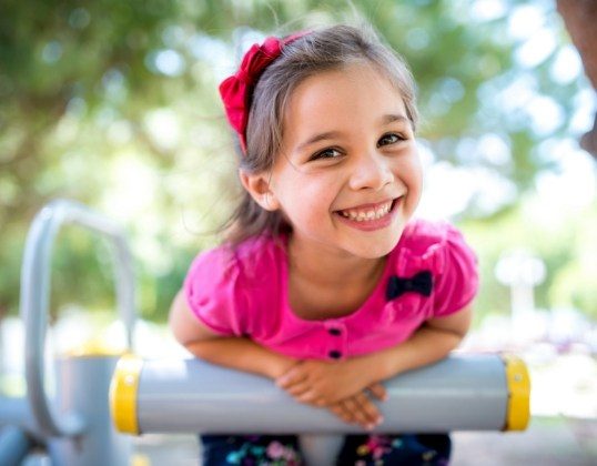 Child on playground smiling