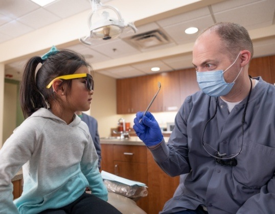 Dentist explaining pulpotomy to child
