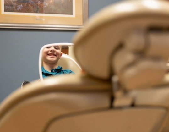 Child looking at healthy smile in the mirror