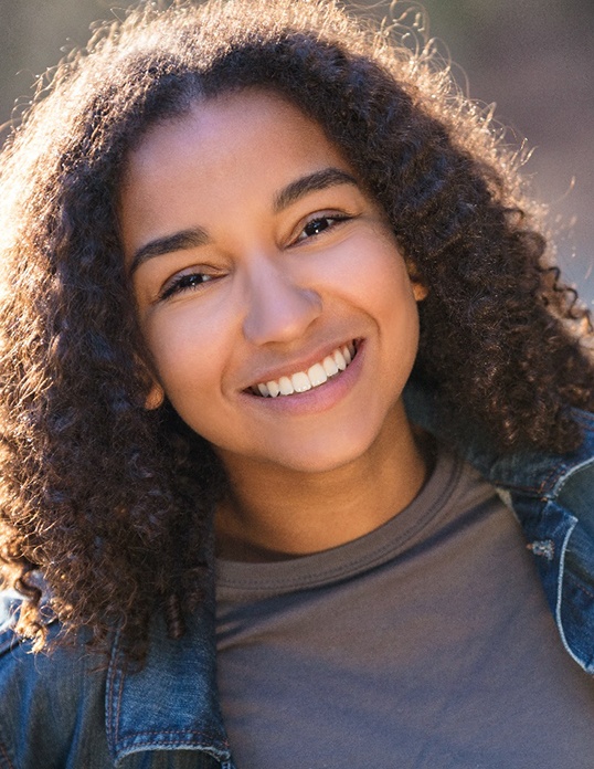 Teenage girl smiling after cosmetic bonding in Castle Rock