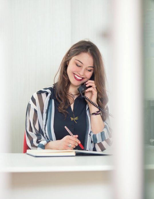 Friendly pediatric dental team member answering the phone