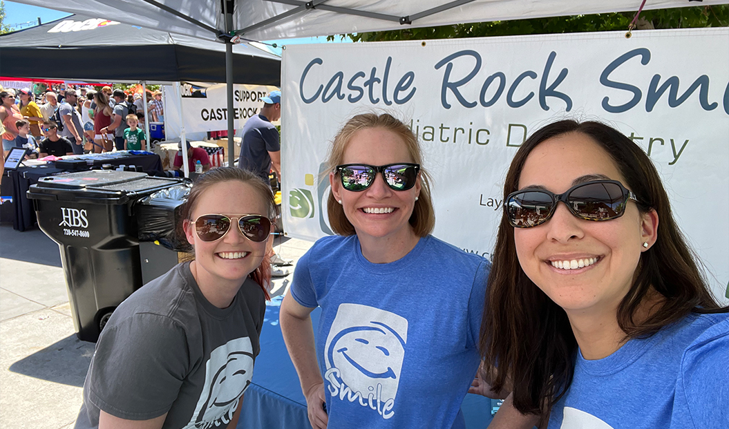 Three smiling pediatric dental office team members