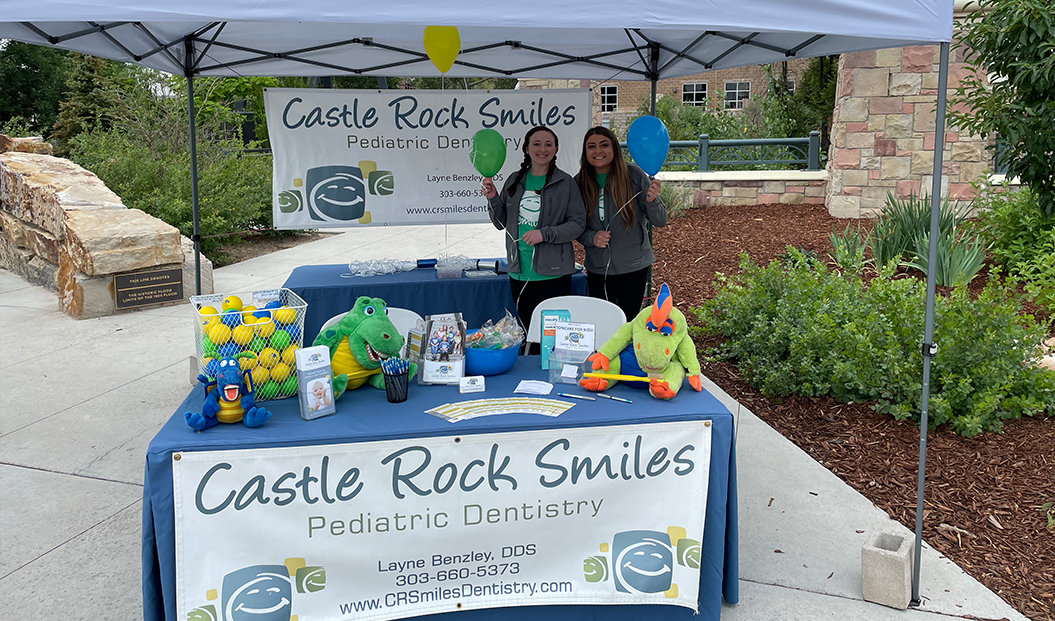 Pediatric dental team members holding balloons