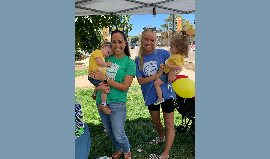 Two pediatric dental team members with children at community event