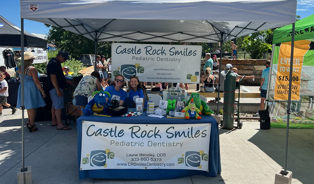 Group of community members at pediatric dental office booth