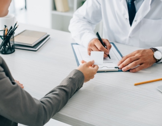 Dentist helping with dental insurance claims