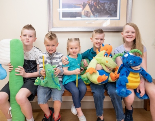 Group of kids smiling in pediatric dental office