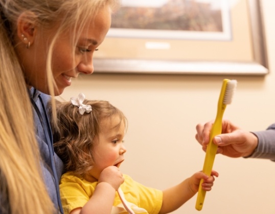 Pediatric dentist providing preventive dental care