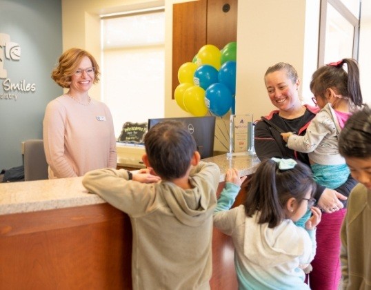 Family discussing the cost of dental emergencies with dentistry team member