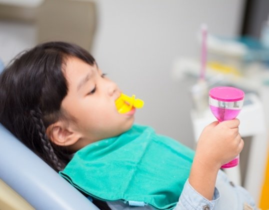 Child receiving fluoride treatment