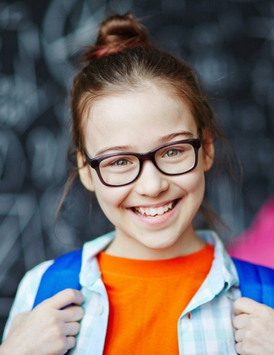 Child sharing smile after pediatric tooth extractions