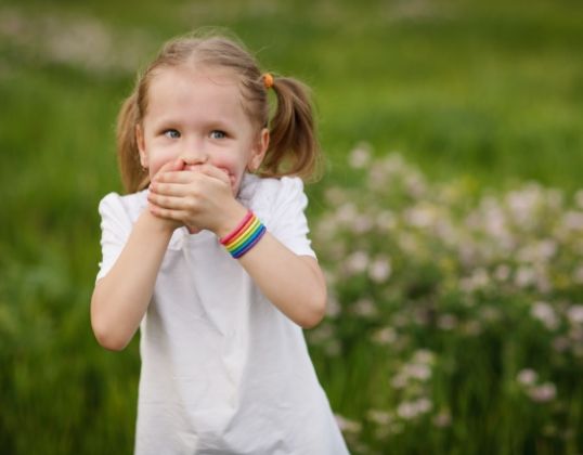 Child covering mouth