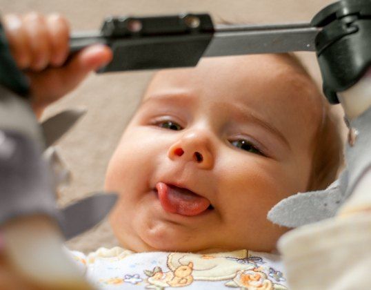 Baby smiling during infant dental exam
