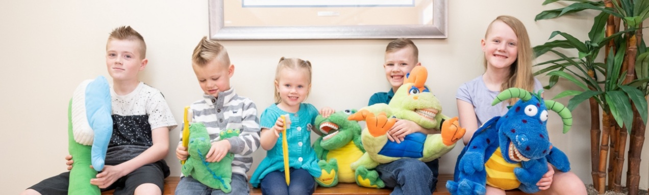 Group of kids smiling after receiving pediatric dental services