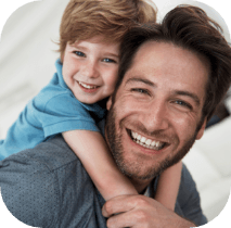 Father and child smiling after restorative dentistry