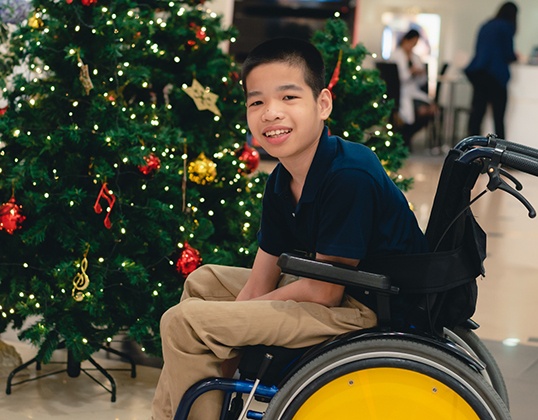 Young boy in a wheelchair smiling