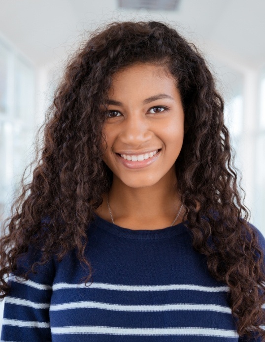 Teen sharing bright smile after teeth whitening