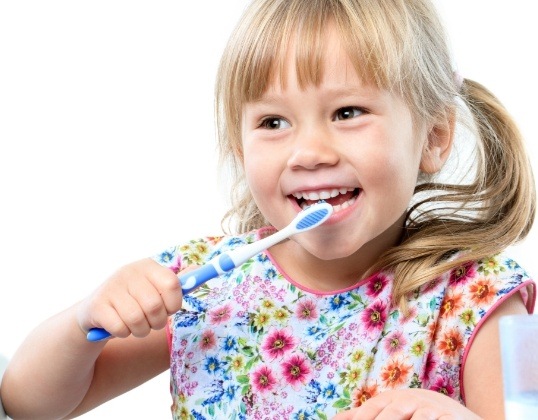 Child brushing teeth to maintain teeth whitening results