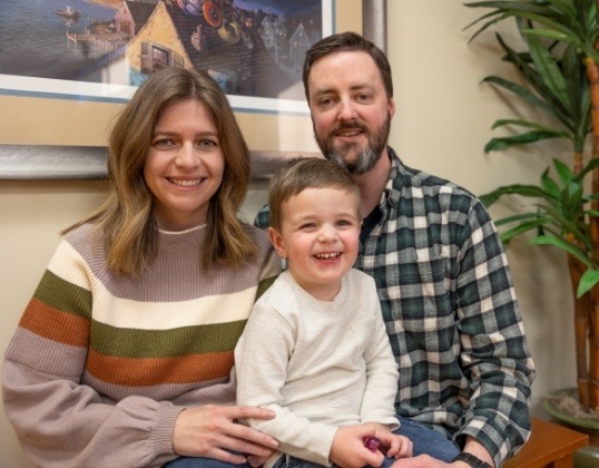 Family of three smiling together