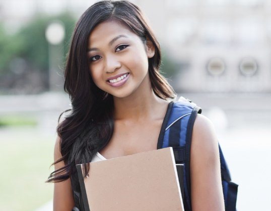 Teen smiling after dentistry for young adults