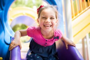 child smiling on playground