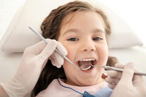 child receiving a dental examination