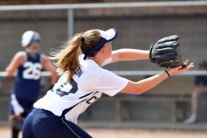 student athlete playing softball and wearing a sports mouthguard