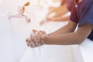 Kids hand washing at the sink