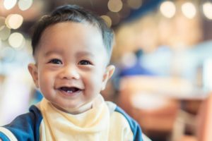 Smiling young boy with his first two baby teeth