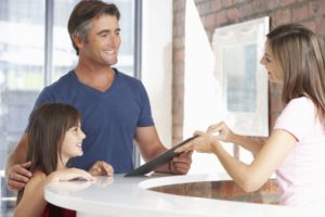 Patient and dentist discussing children's dental insurance coverage