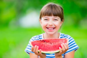 Smiling girl with watermelon and good children's oral health