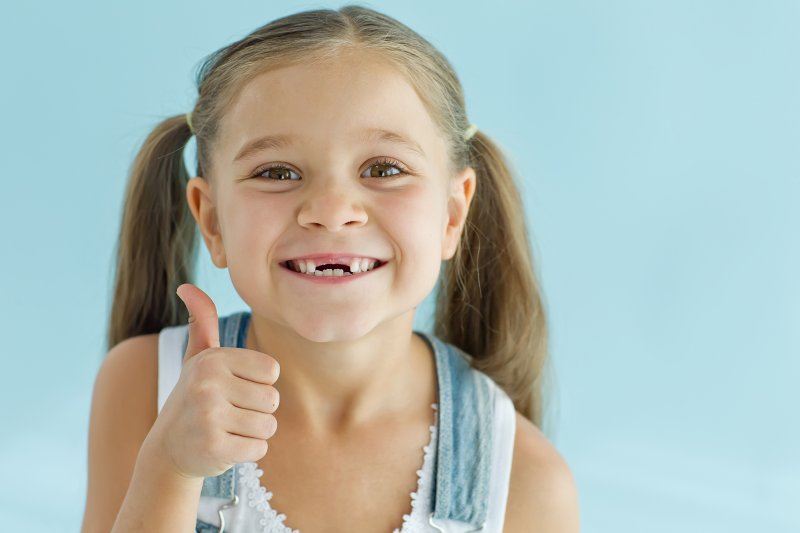 child smiling after tooth extraction