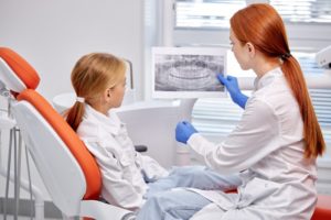 dentist showing child dental x-ray 