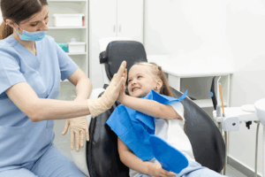 a child smiling at her dentist