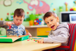 Two children playing with puzzle pieces in a dental office’s waiting room