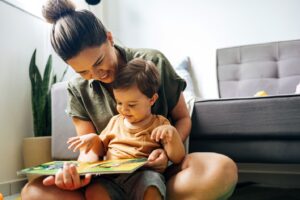 Mother and child reading book together.